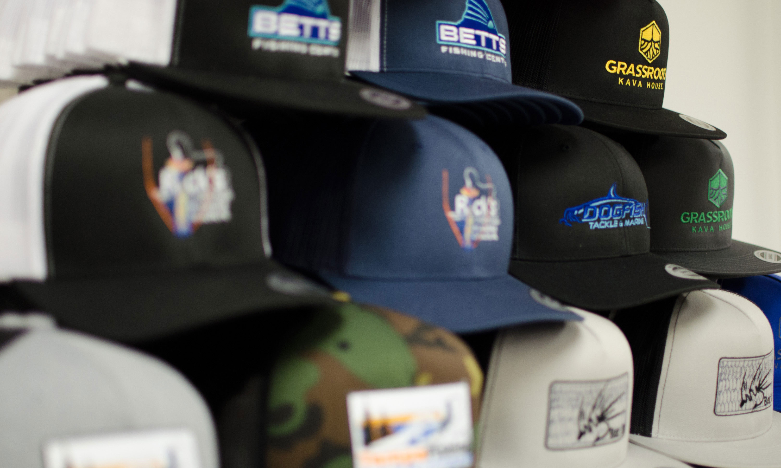 Stack of hats with embroidery or patches attached