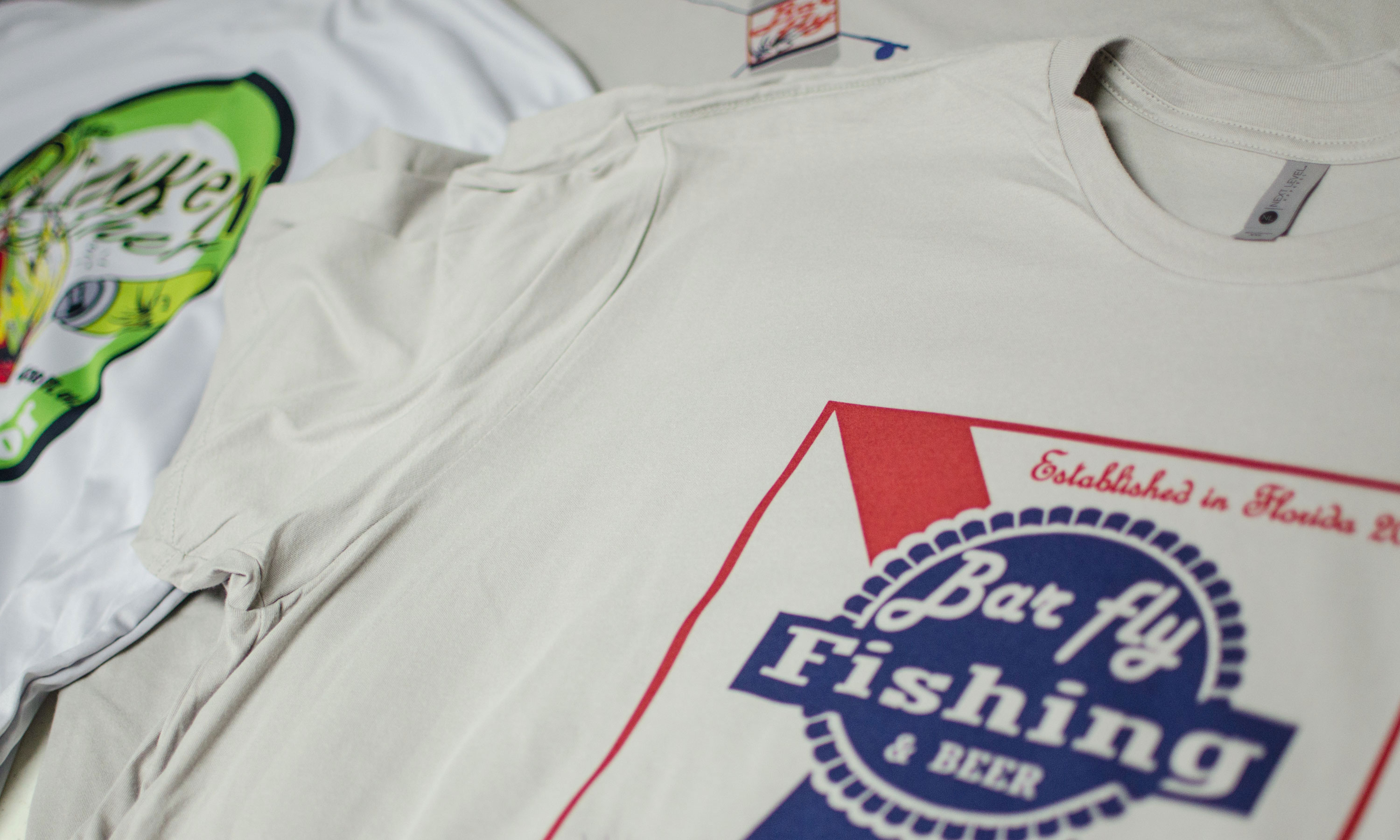 Closeup of Barfly graphics printed on shirts